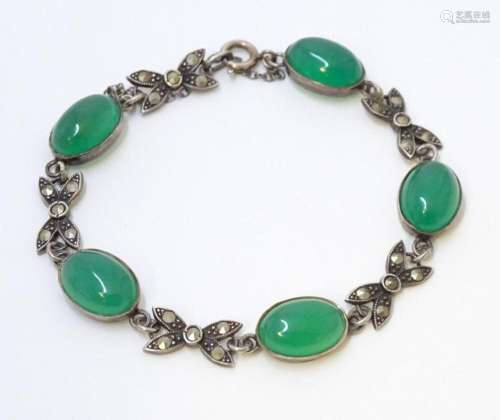 A silver bracelet set with marcasite detail and green jadiet...