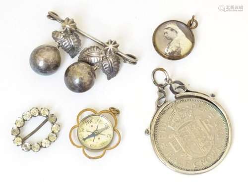 Assorted items to include a pendant compass, pendant depicti...