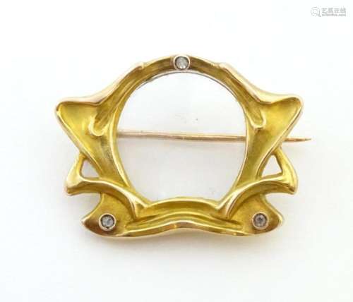 A Continental Art Nouveau gold brooch with central glazed lo...