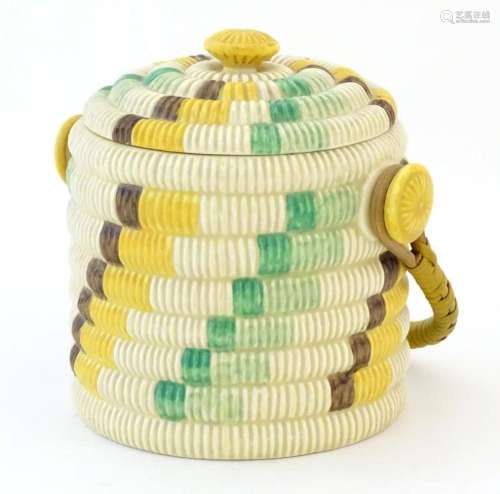 A Clarice Cliff biscuit jar / barrel with swing handle in th...