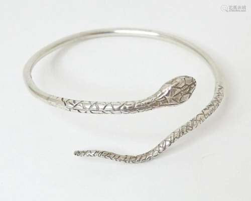 A silver bangle formed bracelet modelled as a snake, hallmar...