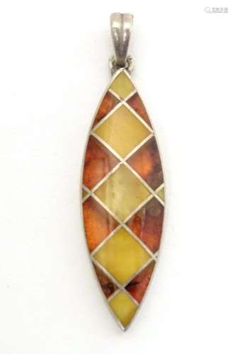 A silver pendant set with amber detail 1 1/2" long