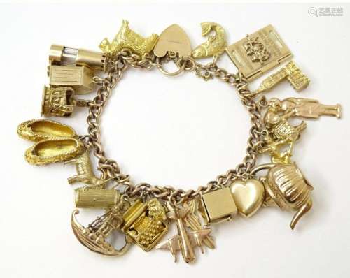 A 9ct gold charm bracelet set with 18 various 9ct gold charm...