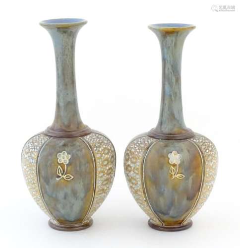 Two Royal Doulton bottle vases with flared rims and floral d...