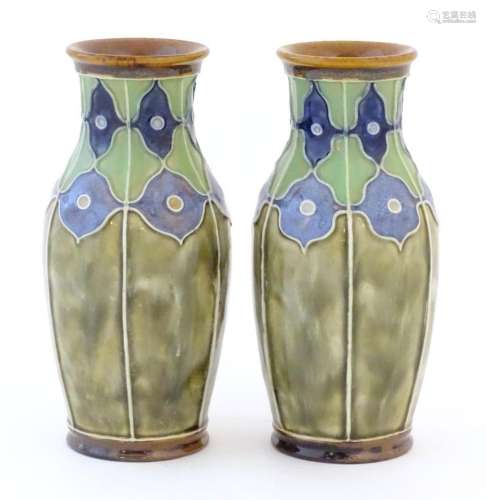 A pair of Royal Doulton vases decorated with stylised floral...