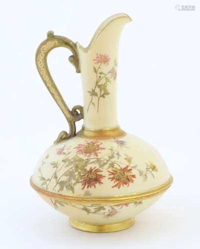 A Royal Worcester jug / ewer with a cream ground, floral dec...
