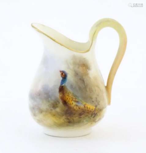 A small Royal Worcester jug with hand painted decoration dep...