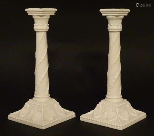 A pair of Royal Worcester candlesticks with relief twist dec...