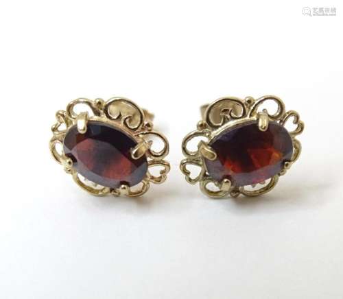 A pair of 9ct gold stud earrings set with garnets. Approx. 1...