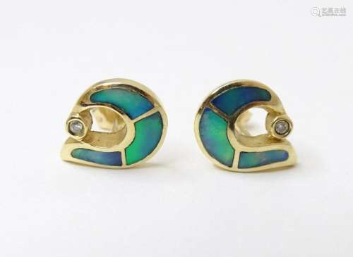 A pair of 14ct gold earrings set with black opal and diamond...