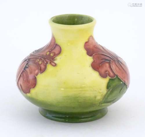 A small Moorcroft squat vase with a yellow ground decorated ...