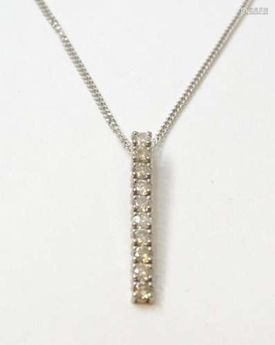 A pendant set with 10 diamonds in a linear setting on an 18c...