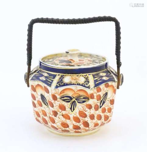 An octagonal biscuit barrel decorated in the Imari palette. ...