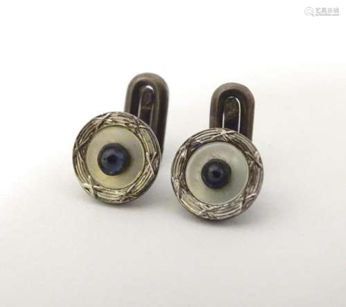 A pair of dress studs marked 900 and set with sapphire caboc...