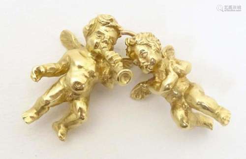 An 18ct gold pendant / charm formed as two cherubs / angels....