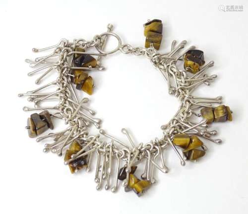 A modernist silver bracelet set with tigers eye detail. Appr...