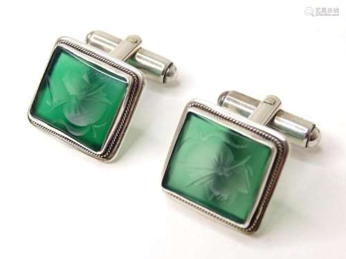A pair of .800 silver cufflinks set with green engraved inta...