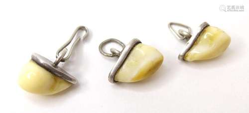 Three hunting trophy pendant charms formed as deer teeth in ...