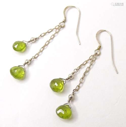 A pair of white metal drop earrings set with green peridot c...