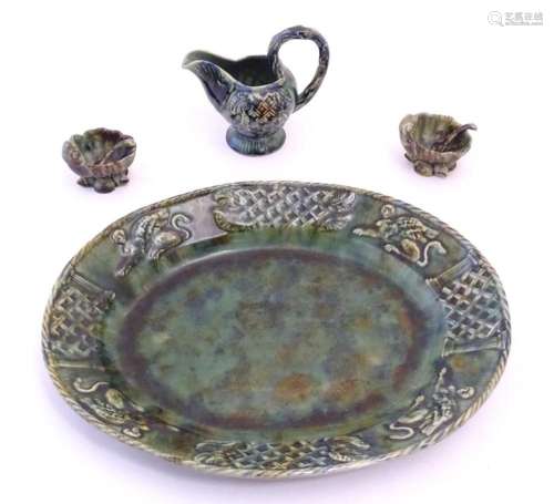 A quantity of Continental majolica wares with a mottled gree...