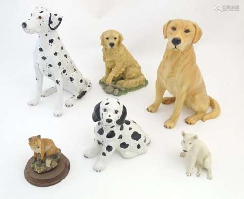 Three assorted ceramic models of dogs to include a large Yel...