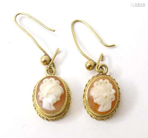 A pair of 14ct gold drop earrings set with classical cameos....