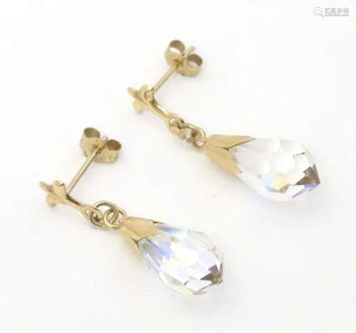 A pair of 9ct gold drop earrings set with facet cut stones. ...