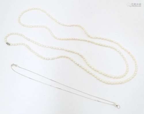 A silver pendant necklace, together with a pearl necklace. P...