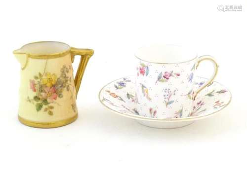 A Royal Worcester coffee cup and saucer decorated with flowe...