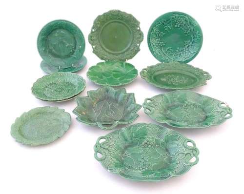 A quantity of assorted green majolica cabbage plates and ser...