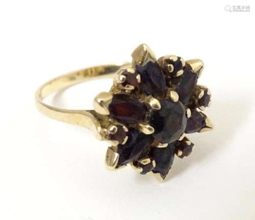 A 9ct gold ring set with garnets. Ring size approx R