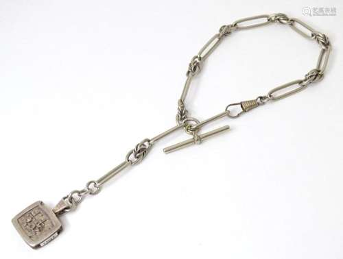 A silver pate watch chain with silver pendant titled  silver...