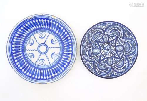 A Spanish blue and white tin glazed plate with stylised flor...