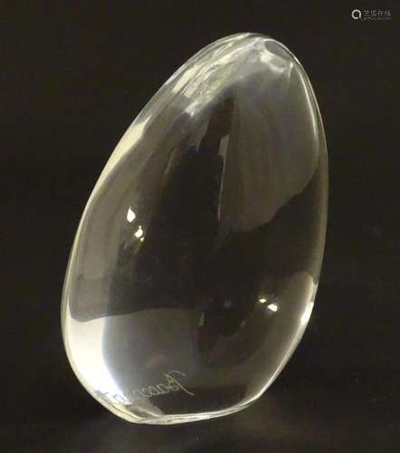 Baccarat glass: a clear glass pebble shaped paperweight with...