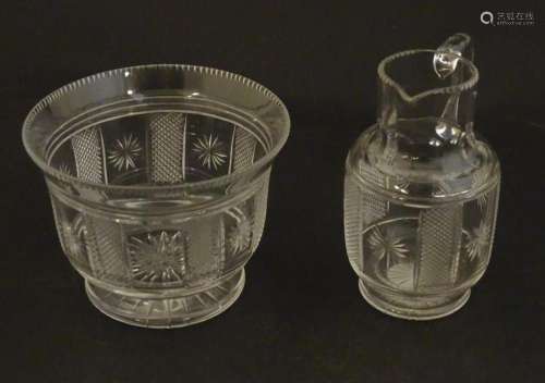 A Victorian glass cream jug and sugar bowl with cut decorati...
