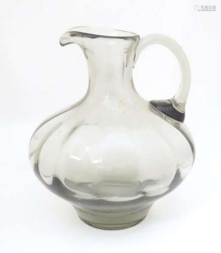 A large glass jug with loop handle approx 10 1/2" high