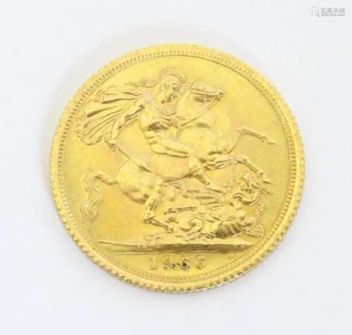Coin: A Queen Elizabeth II 1966 gold sovereign coin. Approx....