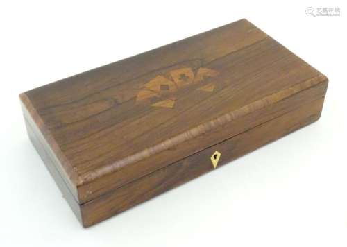 A 19thC rosewood games box, the lid decorated with playing c...