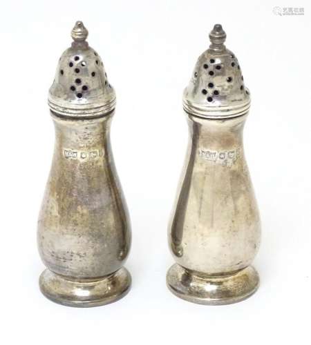 A pair of silver pepperettes, hallmarked Sheffield 1958, mak...