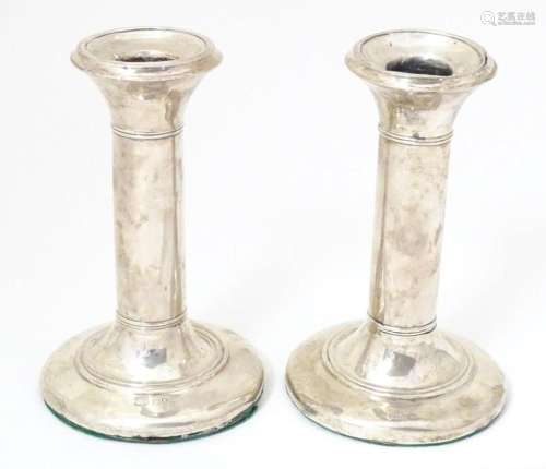 A pair of silver candlesticks hallmarked 1905 maker Charles ...