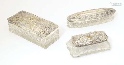 Three various cut glass dressing able boxes with silver tops...