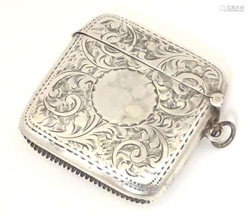 A silver vesta case with engraved acanthus scroll decoration...