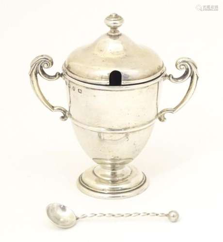A Victorian silver mustard pot of urn form with twin handles...