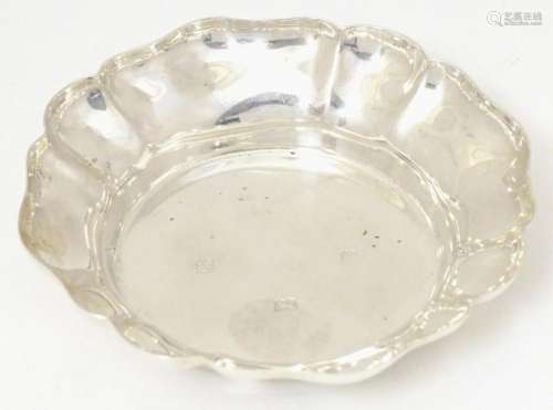 A silver dish of circular form with flared rim, hallmarked B...