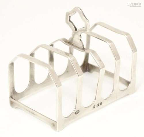 A silver five bar toast rack hallmarked Birmingham 1929, mak...