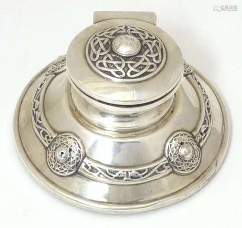 An Arts & Crafts silver inkwell of stylised capstan form...