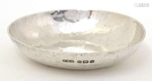An Art Deco small silver dish with hammered decoration hallm...