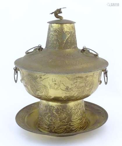 A Chinese cast metal twin handled warming / steaming pot com...