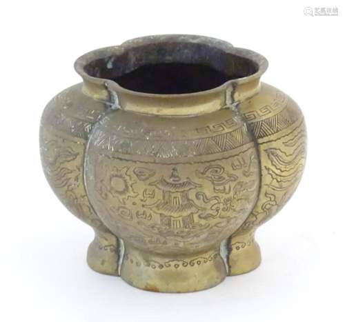 A Chinese brass lobed pot decorated with dragons, phoenix bi...