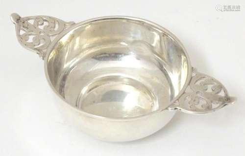 A silver quaich with openwork scroll detail to handles, hall...